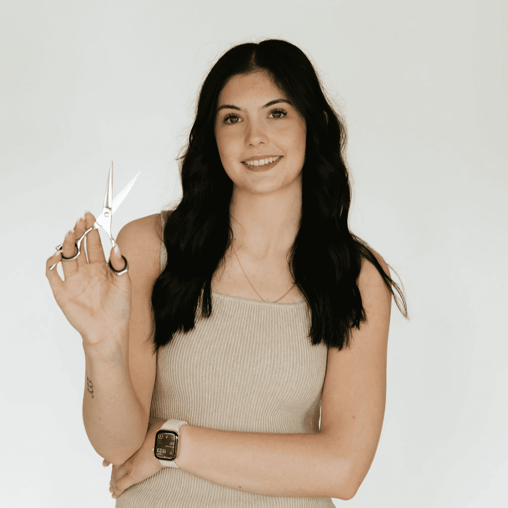 Portrait of Sienna Zollman, a professional stylist at Ashlyn Jamyson Salon & Spa, showcasing their expertise and style.
